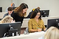 students in a computer lab with professor